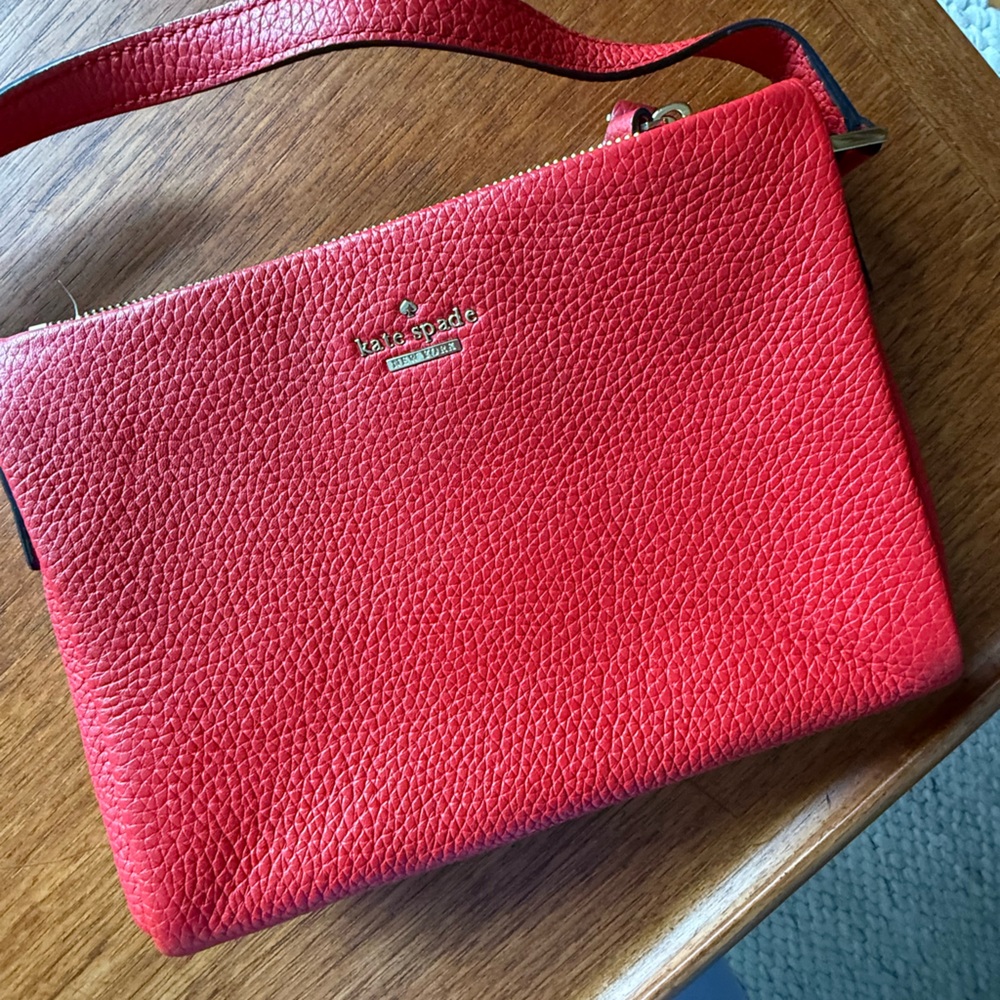 Red Leather Kate Spade Purse with crossbody strap.